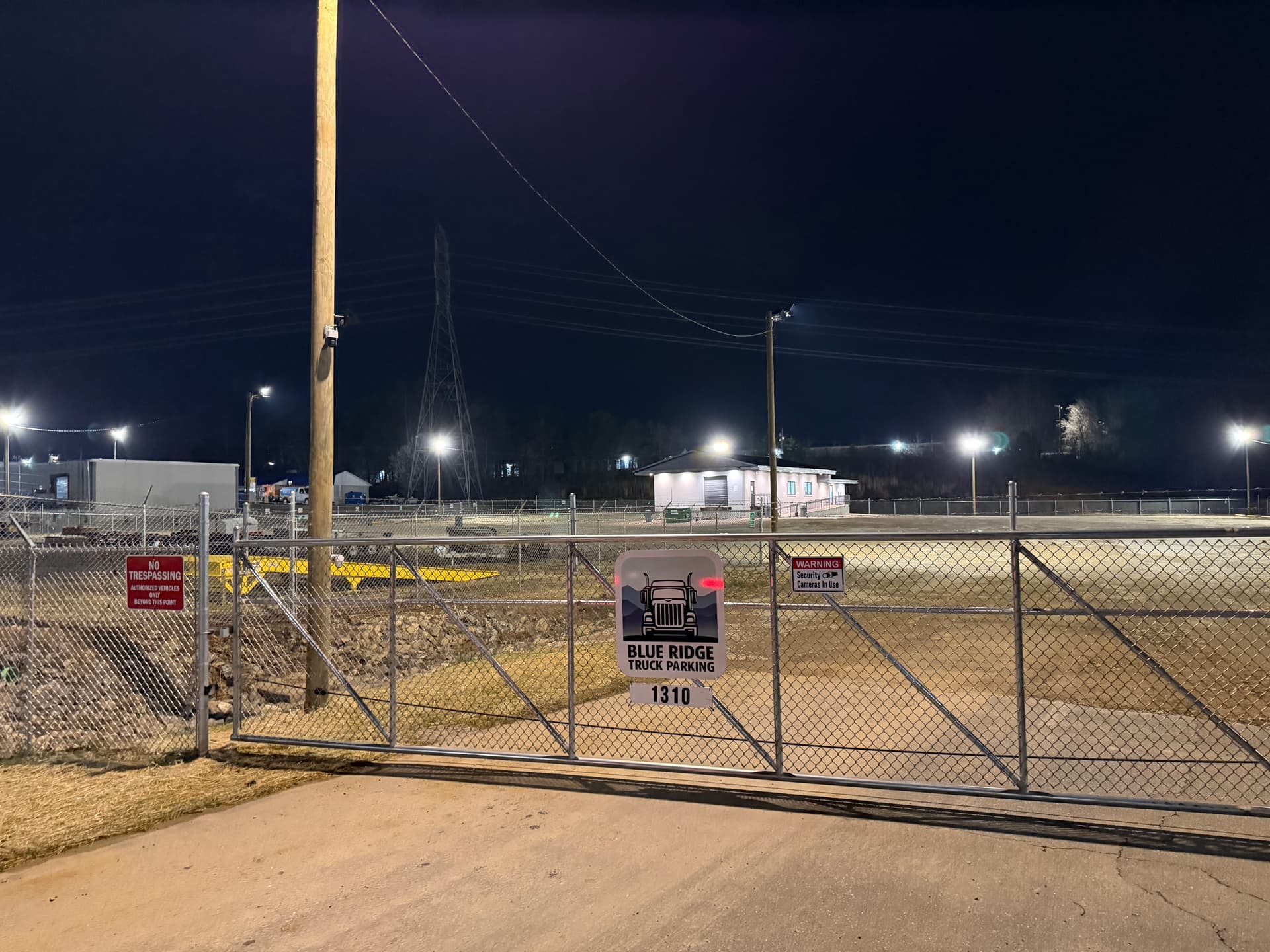 Blue Ridge Truck Parking gated entrance at night, fully lit
